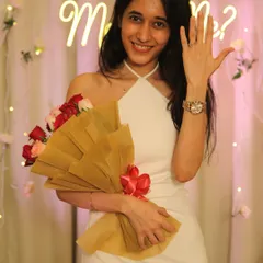 She said yes! A happy client showing off her engagement ring in front of the beautiful decor we set up. The soft lighting and floral details create the perfect background for announcement photos.