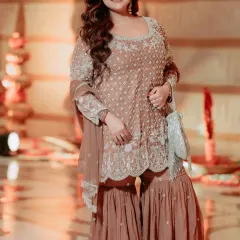 I loved styling my friend for her nephew's Namkaran ceremony. We chose this elegant dusty rose sharara set with intricate silver embroidery. It's a perfect example of styling for family functions, ensuring you look festive and chic.