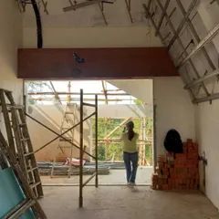 An interior room at the Kolgaon project during construction. This photo shows the raw state of the building, with exposed ceiling framework and brick walls, highlighting the core materials before finishing.