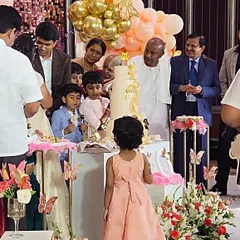I humbly thank the family of our honorable Ex-Prime Minister, Shri H.D. Devegowda, for the privilege of planning this special day. This moment captures the family celebrating around a magnificent butterfly-themed cake, a testament to the trust placed in us.