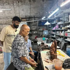I am watching over a student as he puts the finishing touches on his Ganesha idol. It's a moment of shared creation and passing on a tradition.