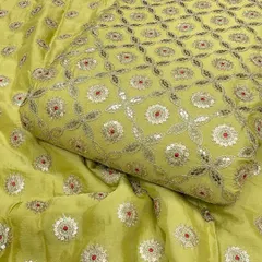 A closer look at the beautiful Gotta Patti embroidery on this lime green Chinon fabric. The combination of silver threadwork, sequins, and a pop of red creates a fresh and festive look.