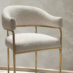 The full view of the bouclé chair and footrest, showcasing its elegant proportions and the balance of modern sophistication and functional design.