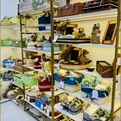 Shelves filled with a wide variety of our handcrafted hampers and gift baskets. This image gives you a sense of the vast range of styles, colors, and sizes we have available to choose from.