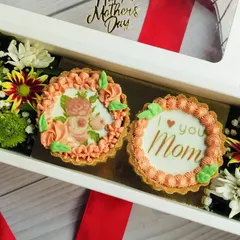 This Chocolate Mini Tart Hamper Box was a special creation for Mother's Day. It includes two custom-decorated chocolate tarts alongside fresh flowers for a beautiful and delicious gift.