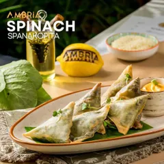 My take on the Greek classic, Spinach Spanakopita. Flaky, golden pastry triangles filled with a creamy spinach and cheese mixture, served with a tangy dip.