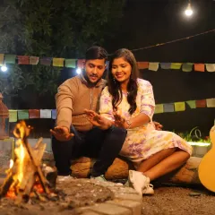 Create a cozy and intimate atmosphere with our unique campfire setup, perfect for a relaxed pre-wedding or couple's shoot. This outdoor setting, complete with a real fire and rustic props like an acoustic guitar, is ideal for capturing warm, natural moments.