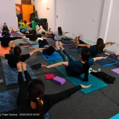 Building core strength is essential for a healthy back and stable practice. This group is engaged in a variation of Navasana, or Boat Pose, to activate their abdominal muscles.