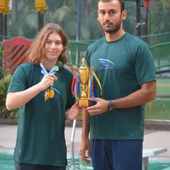 Champion Vivian Pellmar receives her trophy from Coach Virdhawal Khade. His experience competing at the highest level provides invaluable guidance to our team.