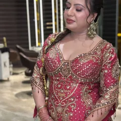 This dewy makeup look was created for a wedding guest. I focused on giving her skin a radiant, healthy glow with soft, shimmery eyeshadow and a warm nude lipstick that complemented her ornate red suit.