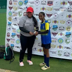 Coach and player celebrating a hard-earned award at their first tournament together.