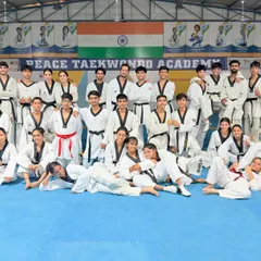 A candid moment with our Peace Taekwondo family. The smiles and relaxed poses show the genuine camaraderie that exists among our athletes after a hard training session.