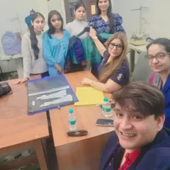 In a portfolio review session with fashion students. A strong portfolio is your entry ticket to the industry. I guide students on how to curate their best work to tell a compelling story about their skills and design philosophy.