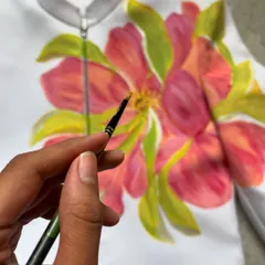 The client wanted a flower design to coordinate with the bride's neon green and pink outfit. I painted this vibrant yet subtle floral piece on the groom's jacket, creating a beautiful connection between their wedding attire.