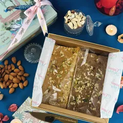 A look inside one of our custom wedding hampers. This box features two types of baked barfi, beautifully wrapped and presented in a personalized box with the couple's wedding hashtag.