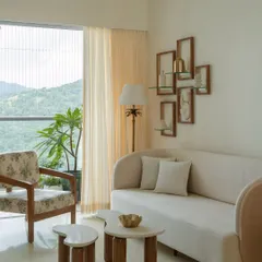 A comfortable and elegant seating arrangement in our "Whitewashed Serenity" project. The custom sofa with its gentle curves and the organically shaped coffee tables create a soft, inviting space, perfect for relaxing and enjoying the mountain view.
