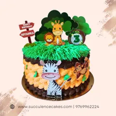 A wild jungle safari theme for a 3rd birthday. This cake features cute, friendly animal characters like a zebra, lion, and giraffe, with piped green grass and chocolate details to create a fun and inviting jungle scene.