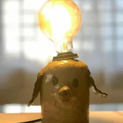 Another look at the adorable dog lamp, lit up and full of character. Seeing your creation come to life after firing is one of the most rewarding parts of the process.
