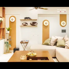 A close-up of the seating area, featuring unique arched wall niches with integrated lighting. These details add architectural interest and provide a beautiful backdrop for curated decor, enhancing the room's character.
