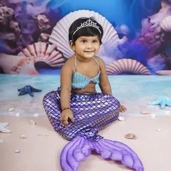 A magical mermaid princess, complete with a sparkly tail and a tiara. This underwater theme is a fantasy come to life.