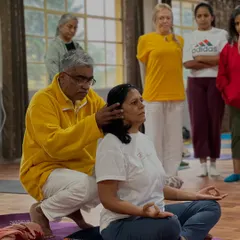 I provide hands-on assistance to ensure proper spinal alignment for meditation. An erect spine is crucial for deep breathing and the upward flow of prana, keeping you alert and focused.