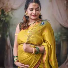 We incorporate meaningful props into our traditional shoots, like this peacock feather, which adds a symbolic and artistic touch to this beautiful saree portrait.