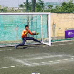 A goalkeeper in mid-air, making a save. This action shot reflects the dynamic and hands-on approach of my entire team.