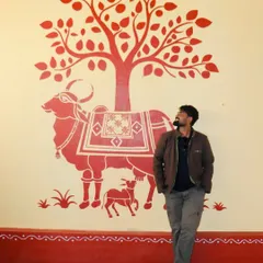 Using traditional Indian art forms like Warli, I tell timeless stories. This mural depicts Kamadhenu, the sacred cow, in the classic, minimalist Warli style, bringing a sense of heritage and peace to the space.
