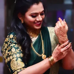 A candid moment of my happy client getting ready for her engagement. Her soft makeup, with a focus on a pretty pink lip, complements her beautiful green and gold embroidered saree.