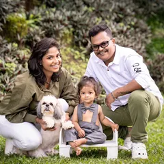 A family portrait taken in a lush green park, complete with their adorable pet dog. I love it when families bring their furry members along for the shoot.