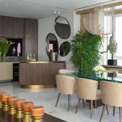 The dining area in the Camellias apartment, set within the larger living space. A custom bar from our Koko collection adds warmth and structure, while a glass-topped table and ethereal Moooi lights create a sense of lightness and poetry.