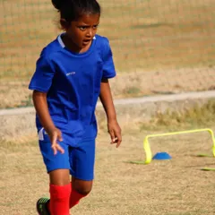 Our summer camps are for everyone. A young female athlete shows great intensity during a practice drill.