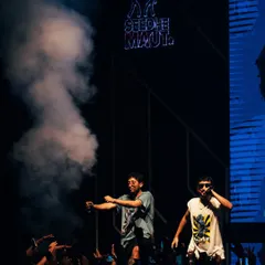 Seedhe Maut electrifies the crowd in Jaipur, blasting a smoke cannon into the audience. This shot captures the duo's signature high-octane energy and their interaction with a hyped-up fanbase.