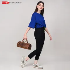 A dynamic, in-motion shot of a model with a small duffle bag. This style of photography is great for social media and ads, conveying a sense of energy and style.