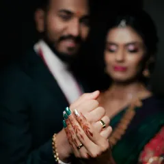 A detail shot focusing on the couple's hands and their new engagement rings. This soft-focus, intimate photo is a beautiful way to announce your commitment and remember the special day.