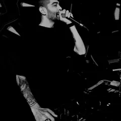 A classic black and white shot of me hyping the crowd. Getting on the mic is a signature part of my performance, essential for keeping the energy at its peak.