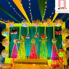 Mehendi nights are all about fun and colour. I designed this vibrant outdoor setup with a mix of colourful drapes, traditional Rajasthani umbrellas, and glowing string lights to create a festive and energetic backdrop perfect for dancing and celebration.