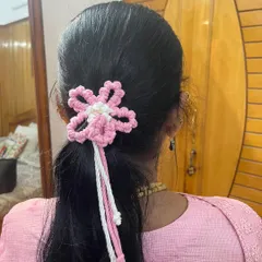 A closer look at the pink and white floral hair tie. The details in the knotting make it a special piece.