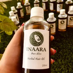 This is my other bestseller, Pure Bliss Herbal Hair Oil. It's formulated to significantly reduce hair fall, combat frizz, and improve your hair's texture and volume, leaving it smooth, shiny, and hydrated.