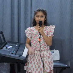 A young vocalist performing at the BEML branch open mic. I ensure a supportive atmosphere where every student feels comfortable on stage.