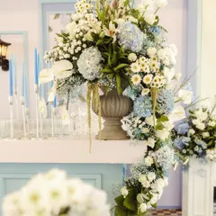 A cascading floral arrangement on the bar. This shows how I use flowers to create movement and drama, with a mix of white lilies, blue hydrangeas, and baby's breath spilling over the counter.