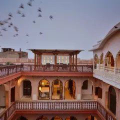 The third-floor terrace offers a stunning view over Chandni Chowk, with landmarks like the Red Fort and Jama Masjid in the distance. This space connects guests to the vibrant life of Old Delhi.