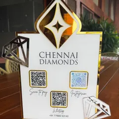 This close-up shot highlights the glossy finish and precise details of the Chennai Diamonds QR stand, including the elegant script and clear code displays.