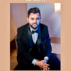 A seated portrait of the groom, looking directly at the camera. This classic pose is perfect for capturing a moment of calm before the celebrations.