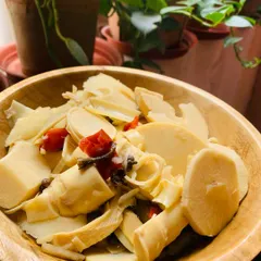 A bowl of sliced fresh bamboo shoots, ready for cooking. The plants in the background are from my own kitchen garden.