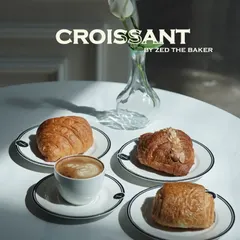 A quiet morning moment captured. My classic butter croissant, almond croissant, and pain au chocolat are served alongside a perfectly crafted cappuccino. Each pastry is a testament to the art of French viennoiserie.