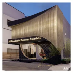 A perspective of the jewellery showroom at night. The circular window offers a curated glimpse into the interior, sparking curiosity while the illuminated signage and architectural lighting work in harmony to create a sophisticated and welcoming atmosphere.