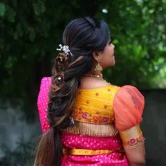 This is a modern twist on a traditional braid. The hairstyle is intricate and artistic, with woven sections and delicate accessories, perfect for a bride who wants a unique look.