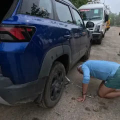 Learning practical life skills is part of the challenge. Here, a participant learns how to change a car tire during our fitness bootcamp.