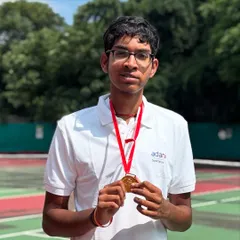 The reward for relentless effort. Lakshmi proudly displays his gold medal after becoming a national champion. Our coaching focuses on building confidence through these milestone achievements, reinforcing the power of perseverance in para lawn tennis.